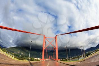 Patagonia, Chile. Red bridge over the fjord. Recently, there was a thunderstorm. The picture was taken Fisheye lens