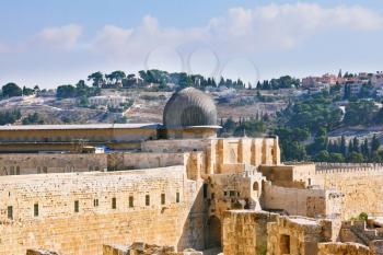 The ancient walls of Jerusalem, lit morning sun. The dome of the Al Aqsa Mosque on the Temple Mount in Jerusalem 