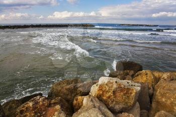 The winter sea. Coastal rocks on quay Tel Aviv