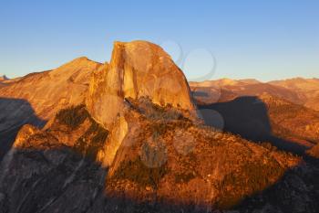 Sunset in national park Yosemite. The well-known top of mountain Half Doum