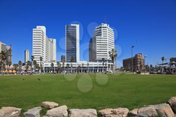 TEL AVIV, ISRAEL - MAY 2, 2014: The picturesque Tel Aviv embankment in sunny spring day. Modern magnificent hotels skyscrapers and green lawns