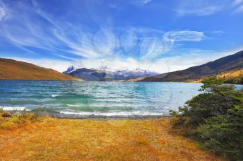 Lake in the high valley of the Patagonian Andes. The sharp strong wind drives the waves with white foam