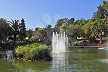 Picturesque lake with islands and fountains. The magnificent city park in Funchal. 