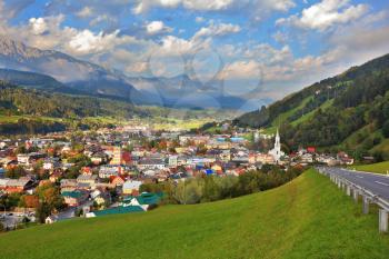 Gorgeous Austria. Mountain valley in the Alps. The picturesque small town is wonderfully illuminated by the sun
