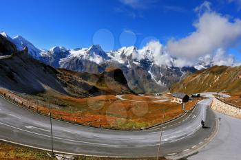 Famous picturesque views of the road in Austrian Alps - Grossglocknershtrasse. The highest mountain peaks covered with fresh snow. Ideal highway winds high in the mountains