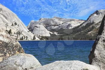 Gorgeous American nature. Tioga blue lake in a hollow among the mountains, the famous Yosemite National Park