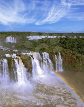 The most famous waterfalls in the world - Iguazu. Magnificent rainbow is above the thundering water jets. The Brazilian side of the falls
