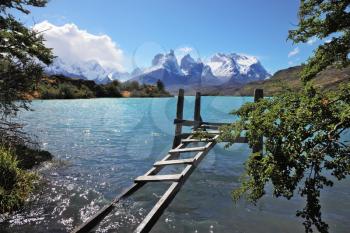  The National Park Torres del Paine, Chile. Boat dock on Lake Pehoe. On the opposite side of the lake majestic snow-capped cliffs of Los Kuernos