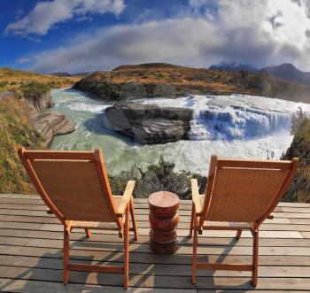 Charming lookout for two. Two convenient comfortable guest sun loungers and a bedside table are worth on a wooden platform. Hence it is convenient to admire cascading waterfall