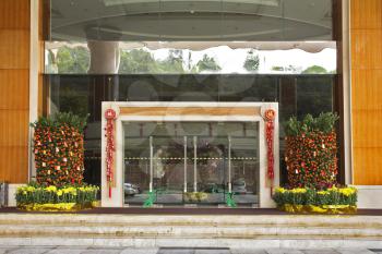 Decorated tangerine-tree entrance to magnificent Chinese hotel