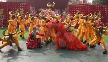 Performance of dancing ensemble in picturesque suits on celebrating of the Chinese New year. An effective final stage 