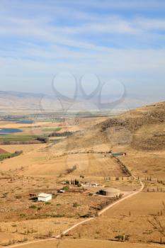 Picturesque Isreel valley. Fields and a farm are photographed from mountain Barkan