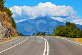 Scenic highway in South America - Carretera Austral. The road leads to the famous volcano Osorno. Top of the volcano cloud closed