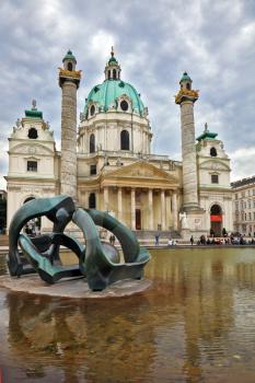 VIENNA, AUSTRIA - SEPTEMBER 26, 2013: The Church of St. Charles Borromeo. On the square in front of the church in  big pond sculpture art nouveau