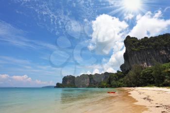 Beach paradise on island Phi-Phi, Thailand. Bright green water of a gulf and light gentle sand

