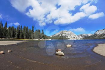 Gorgeous American nature. Tioga blue lake in a hollow among the mountains, the famous Yosemite National Park