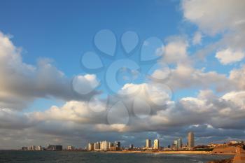  The fluffy clouds shined with the sunset sun. Celebratory quay in Tel Aviv.
