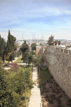 East Jerusalem from the walls surrounding the eternal city. Footpath through the park next to the historic walls