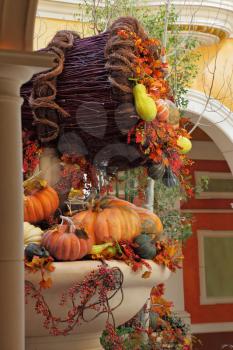 Beautifully decorated lobby luxury hotel. Celebration of harvest: baskets and vases with colorful gourds, flowers and autumn leaves