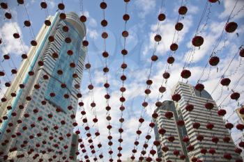 The traditional red lanterns decorating skyscrapers in China in New year