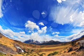 Travel to Chile. The river bends a horseshoe under the flying clouds. The picture was taken Fisheye lens
