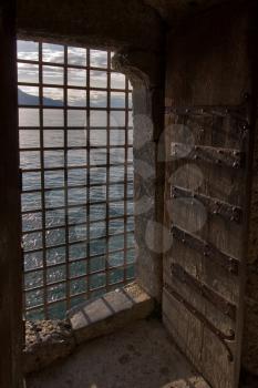  The big window aperture closed by a lattice in a fortress ?hillon on coast of lake Leman