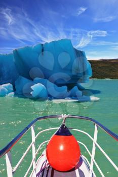 Ice and sun Patagonia. Excursion on the tourist boat on Lake Viedma.  White-blue huge icebergs float near a ship board