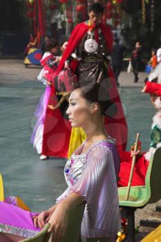 Beautiful Chinese dancers in colourful concert dresses