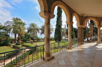 Marble gallery overlooks the landscaped park and the Sea of Galilee. Christian monastery and church