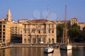  Sailing yachts in Marseilles to port on a background of the ancient buildings, shined by the morning sun