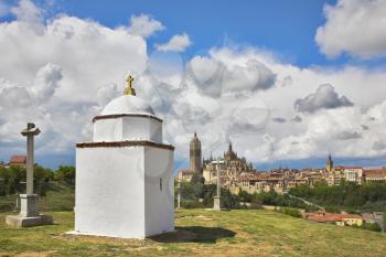 Glade with a chapel and memorable crosses on a background of a Gothic cathedral in Segovia