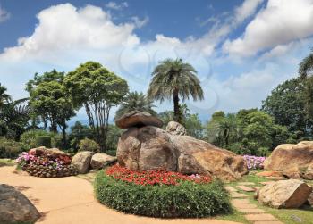 Tropical park  and artly decorated flower beds. Huge picturesque landscape park in Thailand. 