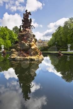 Classical figures decorate a fountain in magnificent park 
