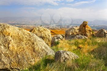  Huge stones in grass in the Jordanian valley