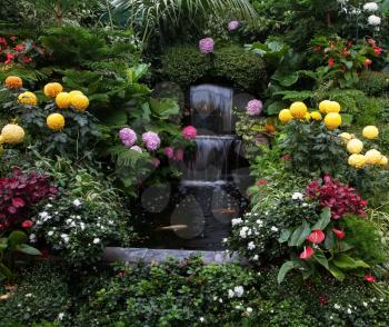 Butchart Garden on Vancouver Island, Canada. Luxury three-stage Fountain Mirror stream among the flowers