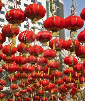 The traditional red lanterns decorating modern skyscrapers, in the Chinese city in New year