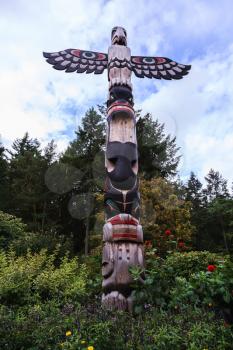 Huge Indian totemic column. Scenic decorative park Butchart Gardens on Vancouver Island, Canada