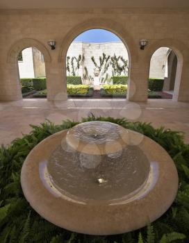 Majestic architectural ensemble in Bahai gardens of the city of Akko: marble pavilion and a round fountain