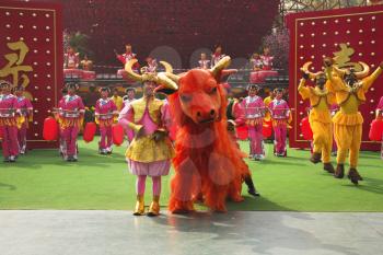 Performance of dancing ensemble in picturesque suits on celebrating of the Chinese New year 