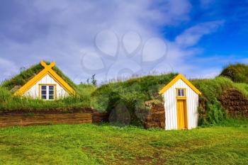  The reconstituted village - museum of the first settlers. Roofs of houses covered with turf and grass. The village ancestors in Iceland