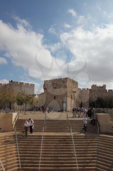 The famous Jaffa Gate in Jerusalem. Tourists on the marble steps in front of Old City

