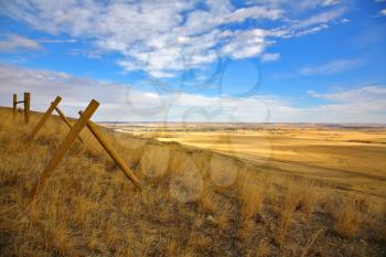 Fence in the American prairie. Serene autumn day