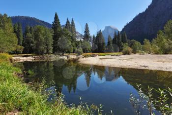 The blue water of the river Merced in Yosemite. Fine autumn day