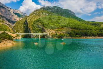  National park Merkantur, Provence, France. Large bridge over the gorge and  river Verdon. White catamarans are sailing on turquoise water
