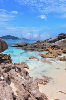 Similansky islands, Andaman Sea, Thailand.
The thinnest white sand of a beach adjoins with huge brown rocks and azure water.