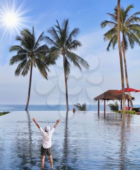 The enthusiastic tourist welcomes sunrise.Magnificent pool on the bank of the Thai gulf.
