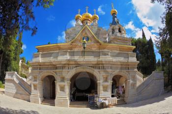 Mount of Olives in Jerusalem. The facade of the church of St. Mary Magdalene white marble.  Above the triangular portico golden domes topped with golden crosses