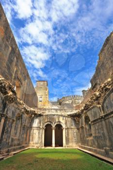 Palace of the Knights Templar in the small town of Tomar, Portugal. Beautiful green inner courtyard, surrounded by a fine building with a beautifully preserved architecture