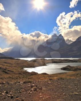 The majestic landscape of Patagonia. National Park Torres del Paine. Fog envelops the mountain range and is reflected in the lake