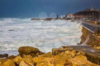 Whole gale in the Mediterranean Sea. Huge foamy waves fight about the coast. New Quay in the Old Jaffa, Israel